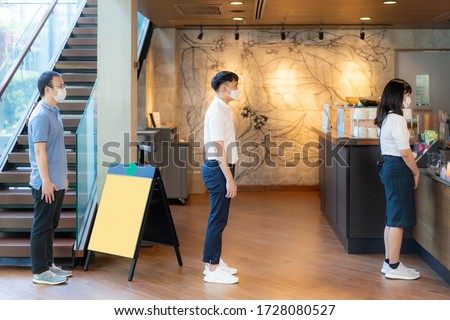 Three Asian people wearing mask standing distance of 6 feet from other people keep distance protect from COVID-19 viruses and people social distancing for infection risk at coffee cafe.
 Royalty-Free Stock Photo #1728080527