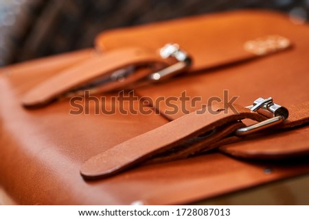 brown leather briefcase with straps closeup
