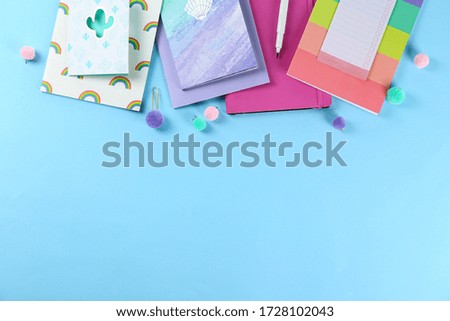 Back to school concept. Set of different school supplies, notebook, pen, accessories on blue paper textured background. Various scolorful stationery items. Close up, copy space, top view, flat lay.