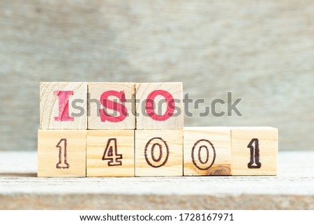 Alphabet letter ISO 14001 in word on wood background