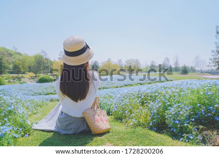 Girls and blue flowers on the hillside