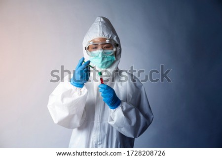 COVID-19,Coronavirus with doctor in personal protective equipment or PPE. holding speciment test tube,vaccination test Royalty-Free Stock Photo #1728208726