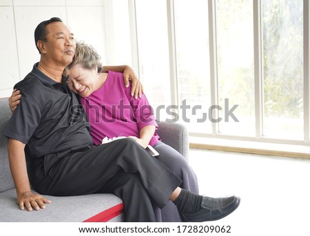 Happy smiling Asian Elderly couple in wedding anniversary in love at home.