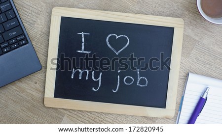 'I love my job' written on a chalkboard at the office Royalty-Free Stock Photo #172820945