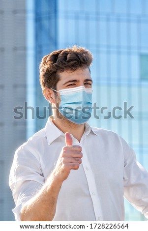 citizen with sanitary mask doing positive gesture with hand