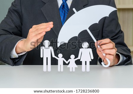 Family life insurance, financial security concept : Businessman protects family members e.g parents and two child, depicts protection from insurer, they will pay a lump sum for clearing burden of debt Royalty-Free Stock Photo #1728236800