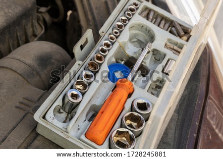 Auto mechanic tool kit. The mechanic has prepared tools for diagnosis and repair. Tools under the hood