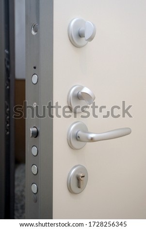 security door - hand close and open the door - security against theft in the apartment - entry and exit - real estate generic picture