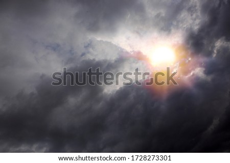 Beautiful sunset sky above gray clouds with dramatic light.