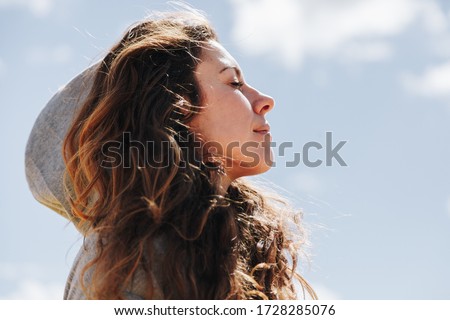 Young woman with hood resting while standing breathes deeply Royalty-Free Stock Photo #1728285076