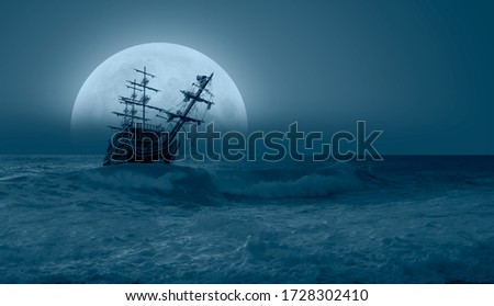 Sailing old ship in storm sea at sunset - Night sky with moon in the clouds "Elements of this image furnished by NASA Royalty-Free Stock Photo #1728302410
