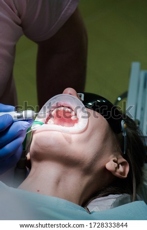 Dentist treat a female patient in dentistry. Treatment concept. Stomatological tool kit. Closeup hightech Dentist equipments.