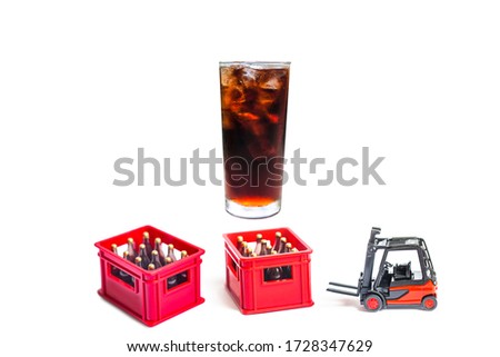 glass of soft drink with ice and miniature toy isolated on white background.