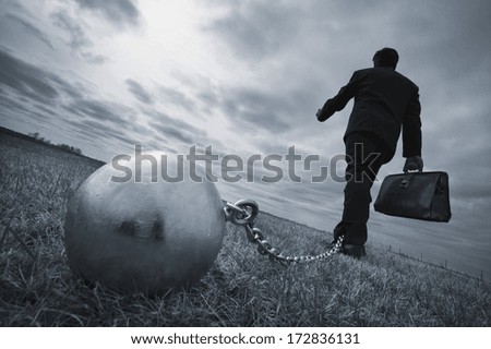 conceptual, businessman tethered and strained by stress, worry, anxiety Royalty-Free Stock Photo #172836131