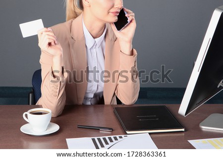 A woman makes purchases online. Unrecognizable photo. A plastic card in the girl's hand. Copy space.