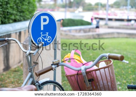 Bicycle parking sign in public garden.
