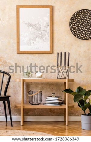 Interior design of living room with stylish black chair, wooden console, books, plant, clock, decoration, grunge wall and elegant personal accessories in modern home decor.