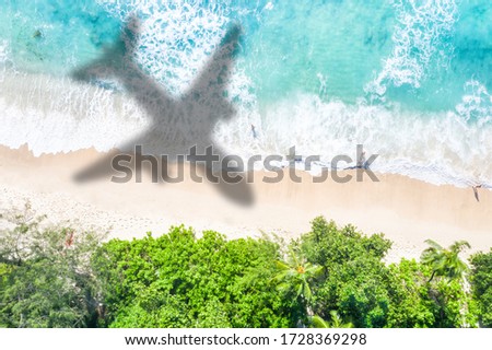 Symbolic picture vacation travel traveling sea airplane flying Seychelles beach waves