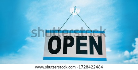 COVID-19 end of confinement stores reopening with OPEN sign hanging on window store front banner background. Retail businesses opening for non essential services.