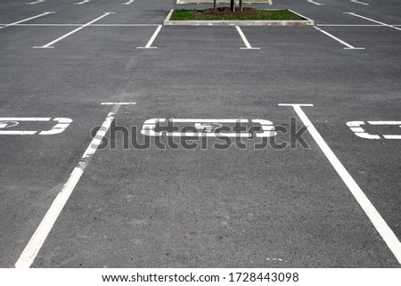 public empty parking with separate paint spots for the disabled