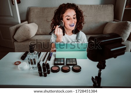 
Young woman making a video tutorial with her tablet on how to put makeup on step by step to include it on her blog. Enhancing E-learning during the quarantine caused by covid19. Lifestyle