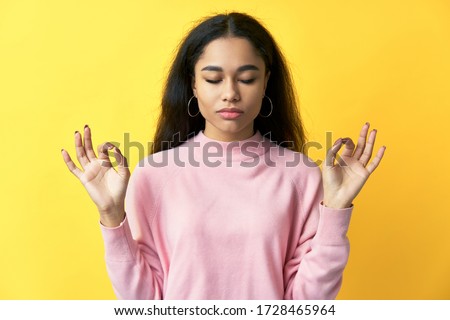Relaxed pretty woman keeps hands in mudra gesture with eyes closed. meditation, patience concept Royalty-Free Stock Photo #1728465964