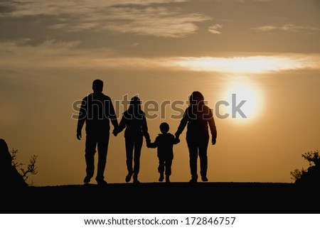 silhouette of family on the outdoor at dusk. 