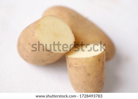 Raw potato on neutral background