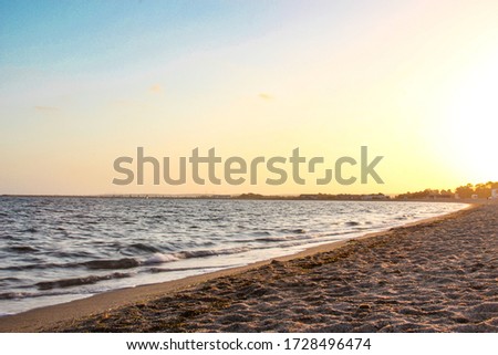 Sand and sunset. Landscape ocean beach with blue sky.