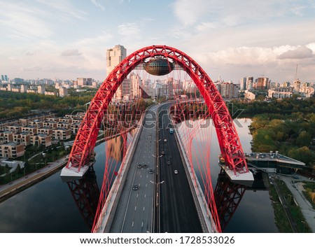 Aerial view of red cable-stayed Zhivopisniy bridge at sunset, Moscow, Russia. Royalty-Free Stock Photo #1728533026