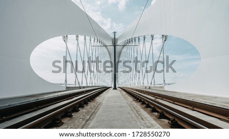 Railroad under a bridge columns