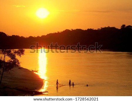 Kids playing with fishing net in Inirida river Royalty-Free Stock Photo #1728562021
