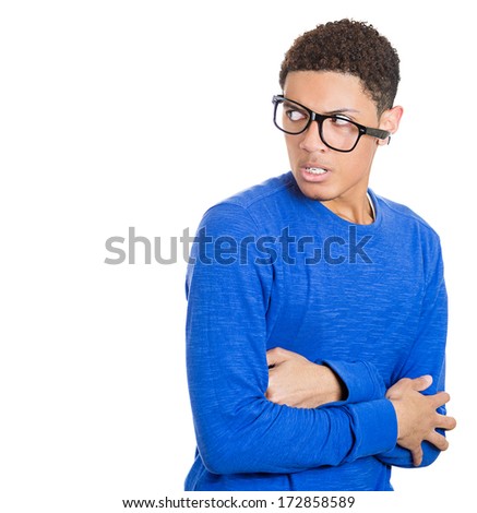 Closeup portrait of a young nerdy looking man with glasses, very timid, shy and anxious, playing with hands nervously, isolated on a white background. Mental health, emotion facial expression feeling