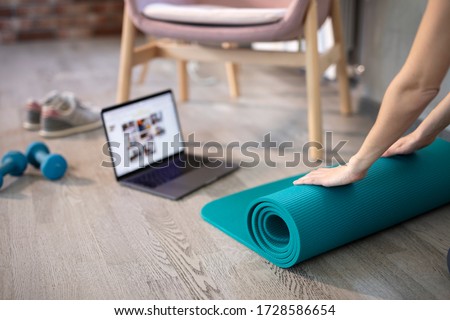 Young sporty slim woman preparing for online fitness training with modern laptop. Healthy lifestyle concept, online fitness and sport lessons.  Royalty-Free Stock Photo #1728586654