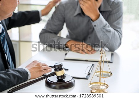 Judge gavel with scales of justice, Businessman and lawyer or counselor consulting and discussing contract papers at law firm in office. Royalty-Free Stock Photo #1728589501