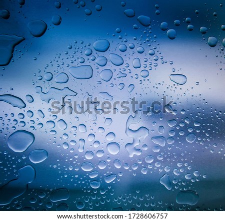 Water drops on metal surface texture background. Transparent, steel, blue.