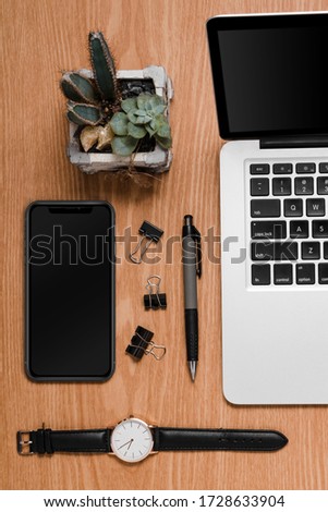 Office desk accessories in a woody background