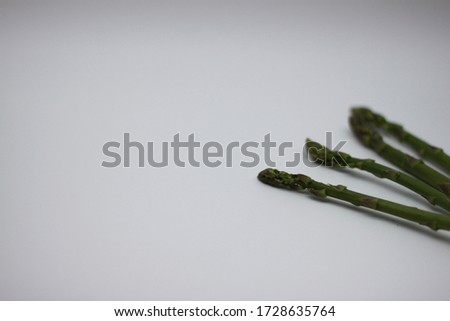 raw wild asparagus on white background