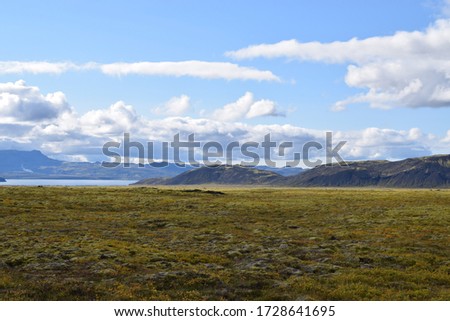 Idealistic Icelandic landscape containing water and beautiful clouds in the sky 
