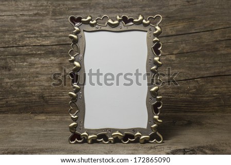 Empty photo frame on a wooden background