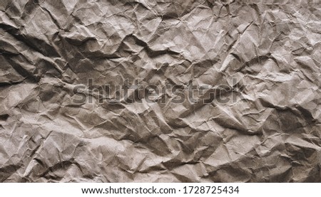 Crumpled vintage background from paper, which is used as a wrapper. The texture of cardboard made from recycled materials.