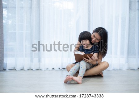 mother reading book for her child, read cartoon book, Storytelling with children
