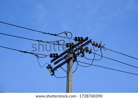 Electricity pole isolated on blue sky background