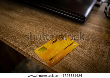 A picture of a yellow credit card placed on an employee's desk
