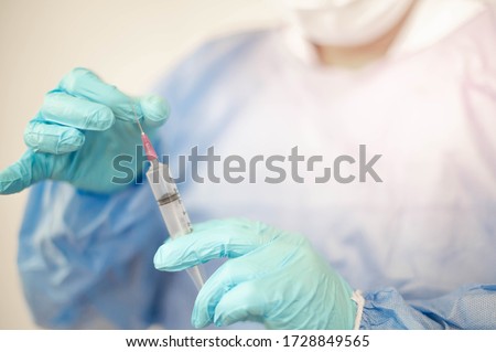 Syringe medical injection in hand holding with medicine dose vaccination equipment with needle. vaccination to patient for coronavirus (COVID-19) protection. Coronavirus pandemic world of crisis. 