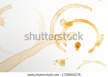 Abstract liquid drops splash brown coffee on a white texture paper background for watercolor. Artistic decoration or backdrop. Banner for text, grunge element.
