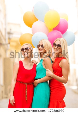 holidays and tourism, friends, hen party, blonde girls concept - three beautiful women with colorful balloons in the city