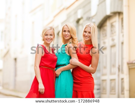 holidays and tourism, friends, hen party and blonde girls concept - three beautiful women in the city