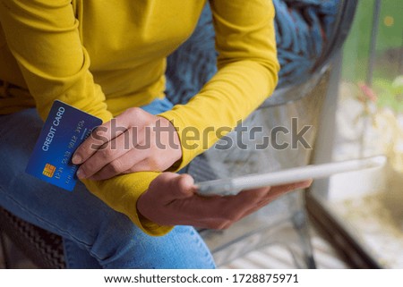 Woman hands holding tablet with credit card for Online shopping.