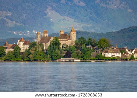 View of old city of Rapperswil dominated by its 13th century castle and the alps in the background, St. Gallen, Switzerland